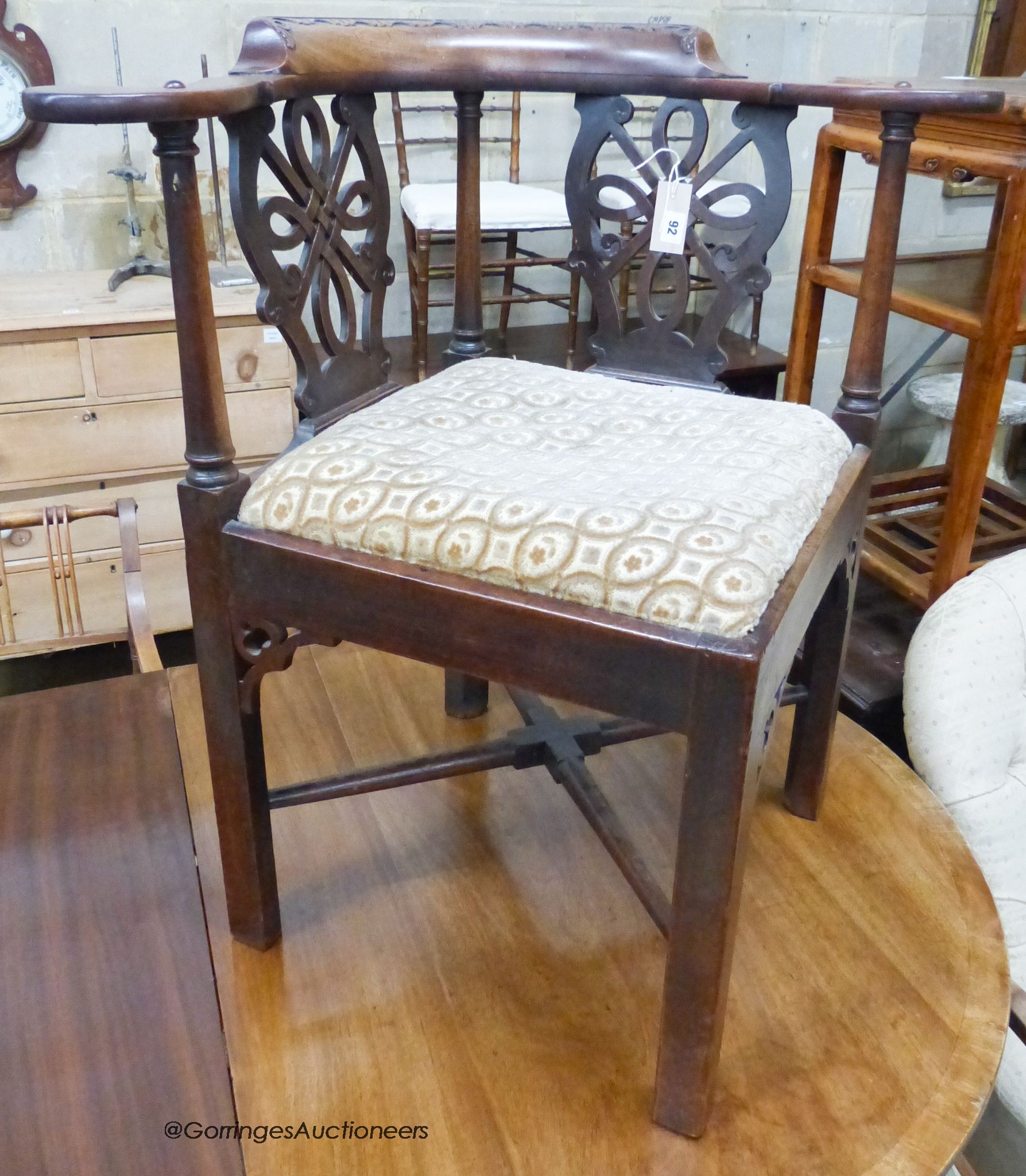 A George III carved mahogany corner elbow chair, width 82cm, depth 66cm, height 84cm